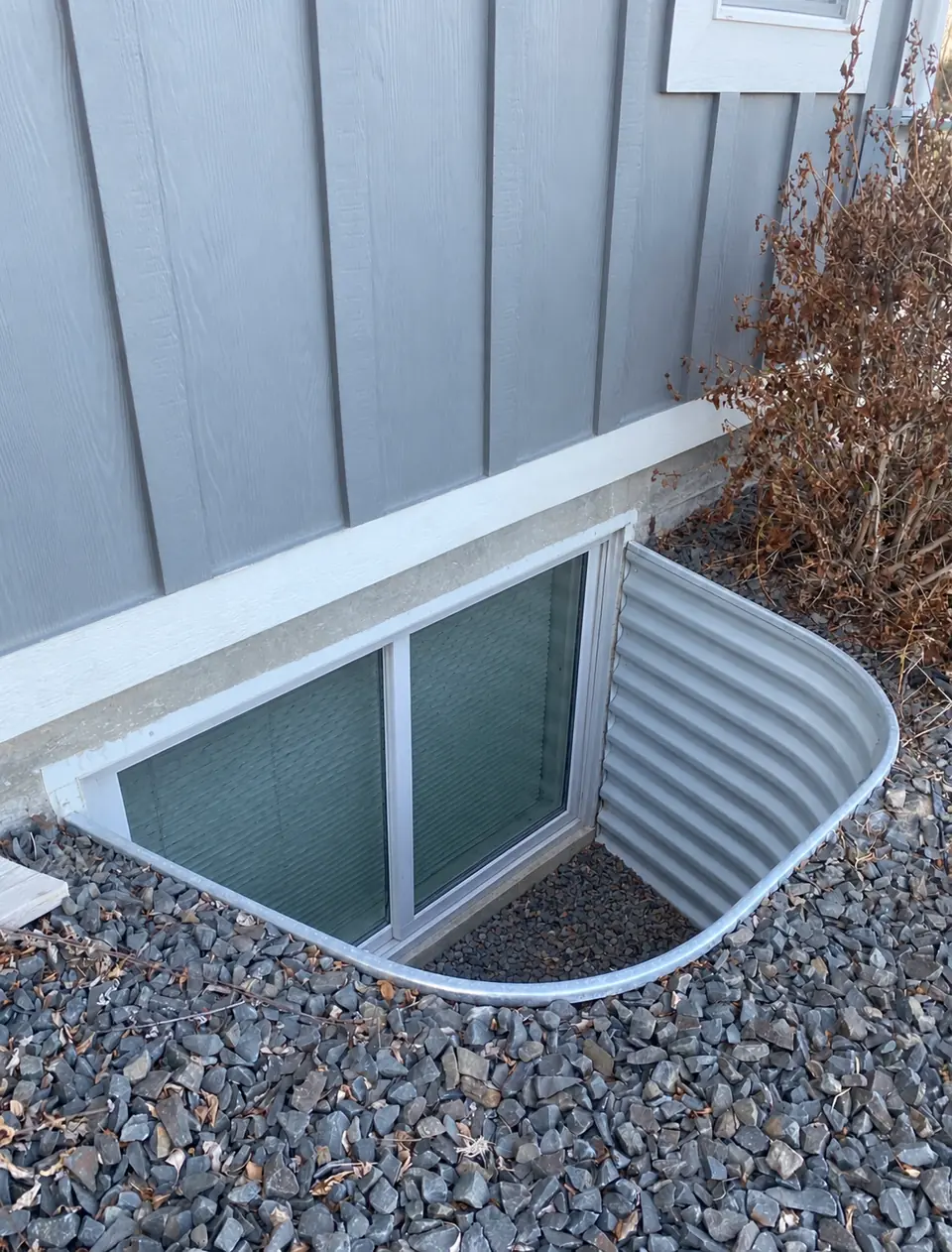 Illustration of the same window well without its cover; not an actual before photograph